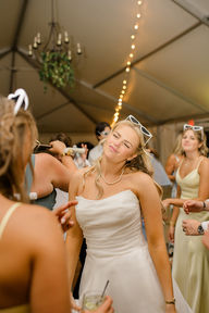 A bride dancing with her bridesmaids