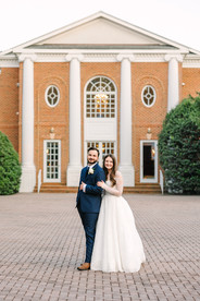 Newlyweds posing in front of wedding venue Rose Hill Manor