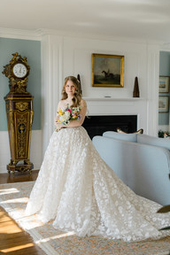A bride holding her bridal bouquet in a house