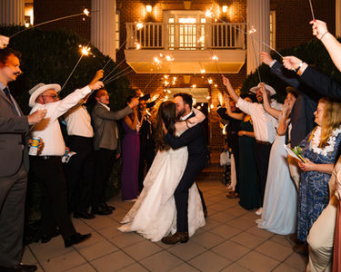 Bride and groom kiss during grand exit
