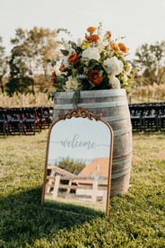 Mirror wedding welcome sign on a barel
