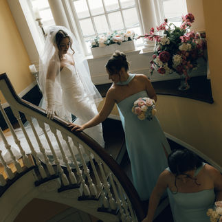 Bride and Bridesmaids Walking Down Stairs