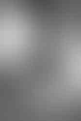 A bride in her wedding dress looking out the window