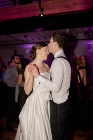 Groom kisses his bride's forehead