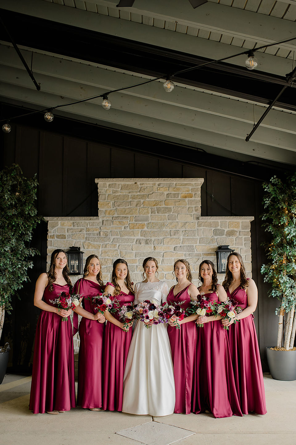 A bride and her bridesmaids smiling at camera