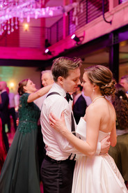 Groom hugs his bride during final dance