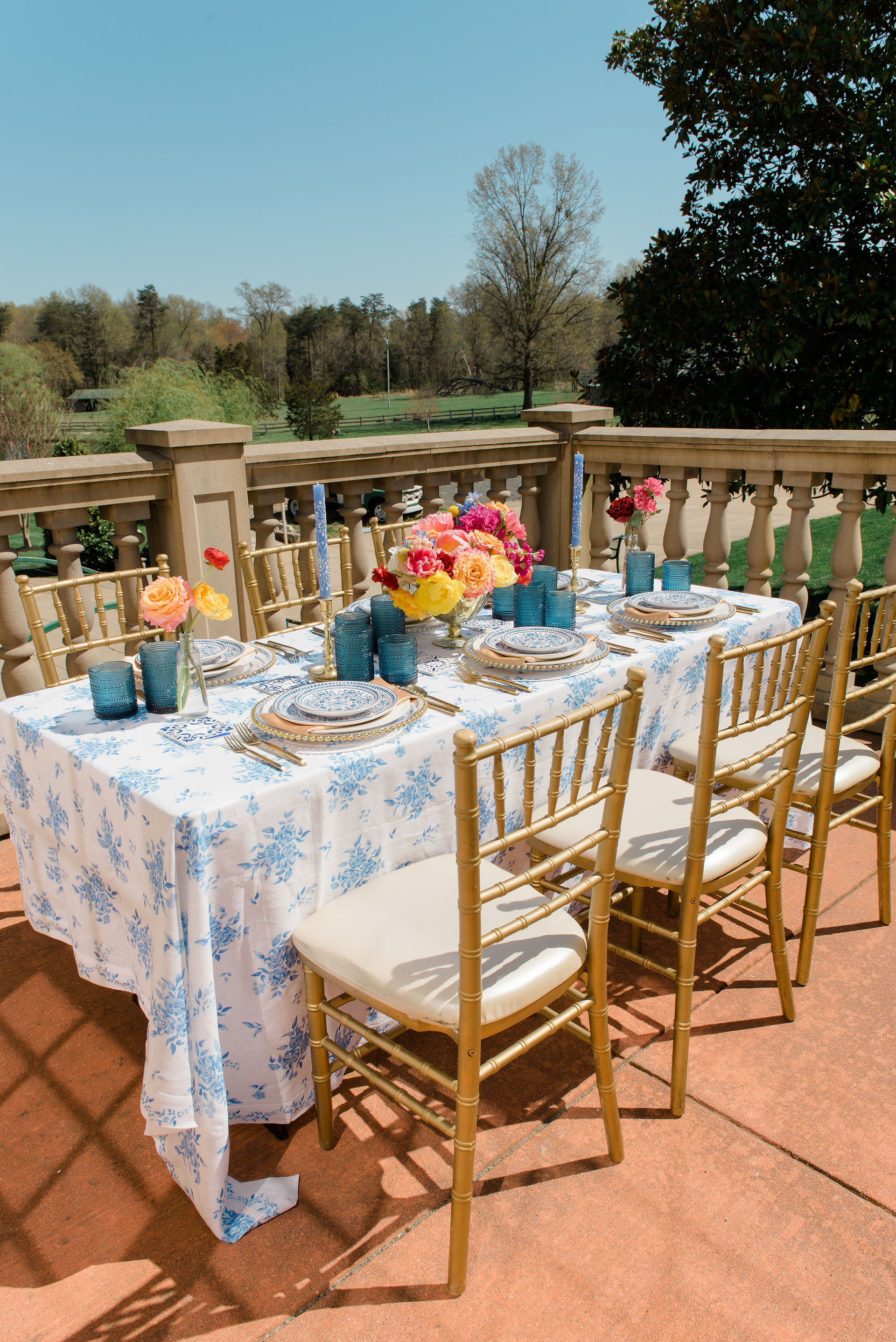 an outdoor table on a balcony overlooking landscape