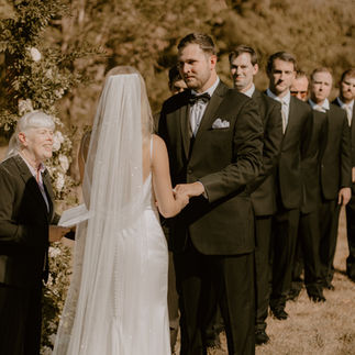 Bride and Groom Holding Hands at Altar