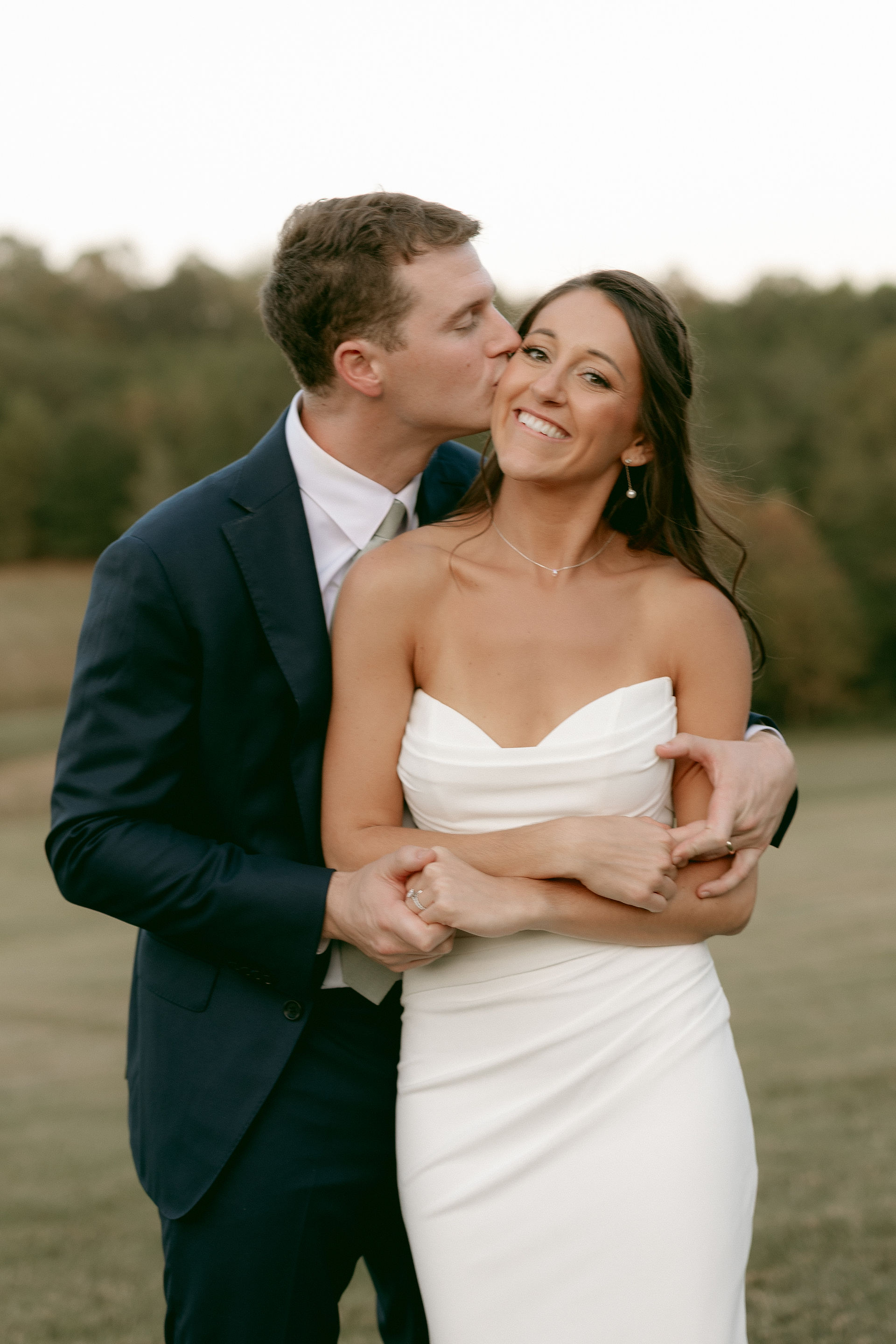 Groom Kissing Brides Cheeks 