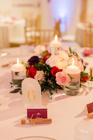 Floral centerpieces with candles on a guest reception table