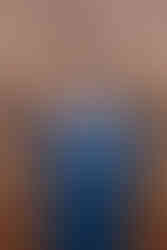 A groom putting on his tie