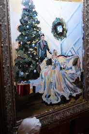 A live painting of a bride and groom next to a Christmas tree