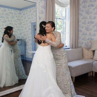 Mom hugging bride in bridal suite