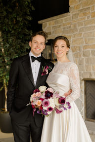 Newlywed couple smiles at the camera