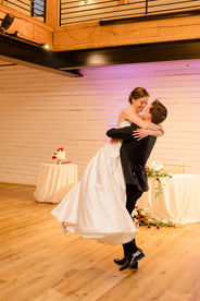 Groom lifts bride into the air to spin