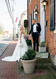 A bride and groom holding hands at Birkby House