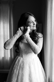 A bride putting on her earrings