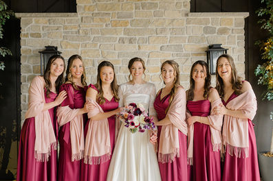 A bride and her bridesmaids smiling