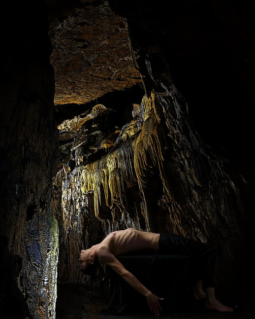 Body lying in a dark cave