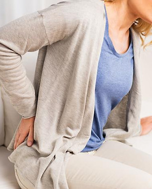 woman grabbing her hip in pain