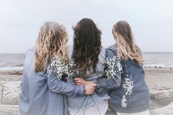 Three women sitting on beach_edited_edited.jpg