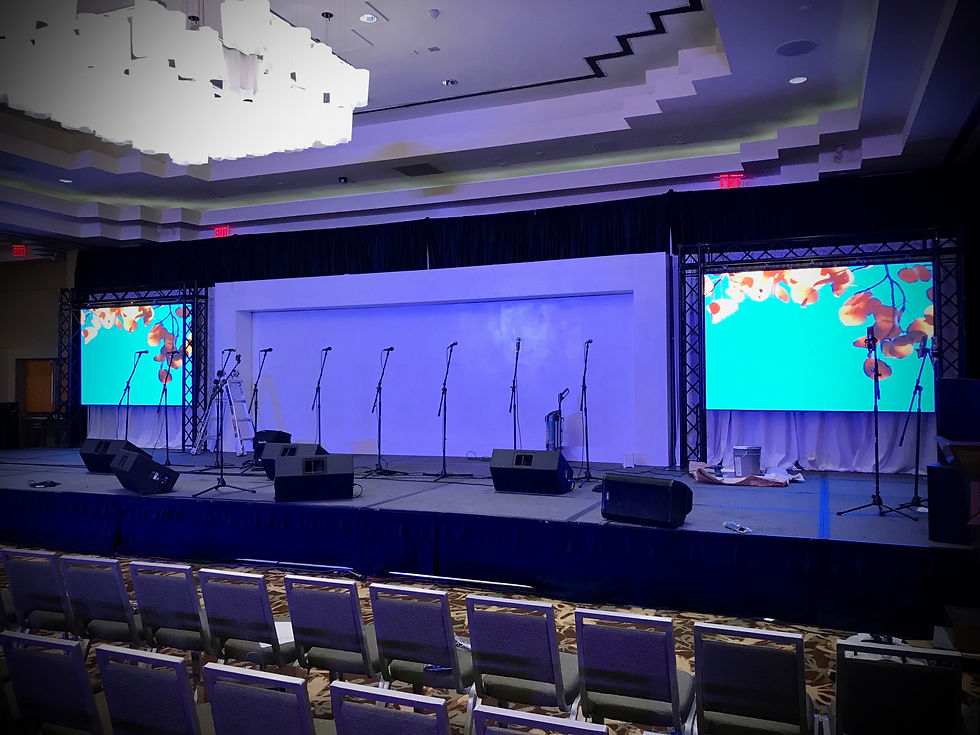 Event stage with microphones and screens, ready for presentation. Stage Rental.