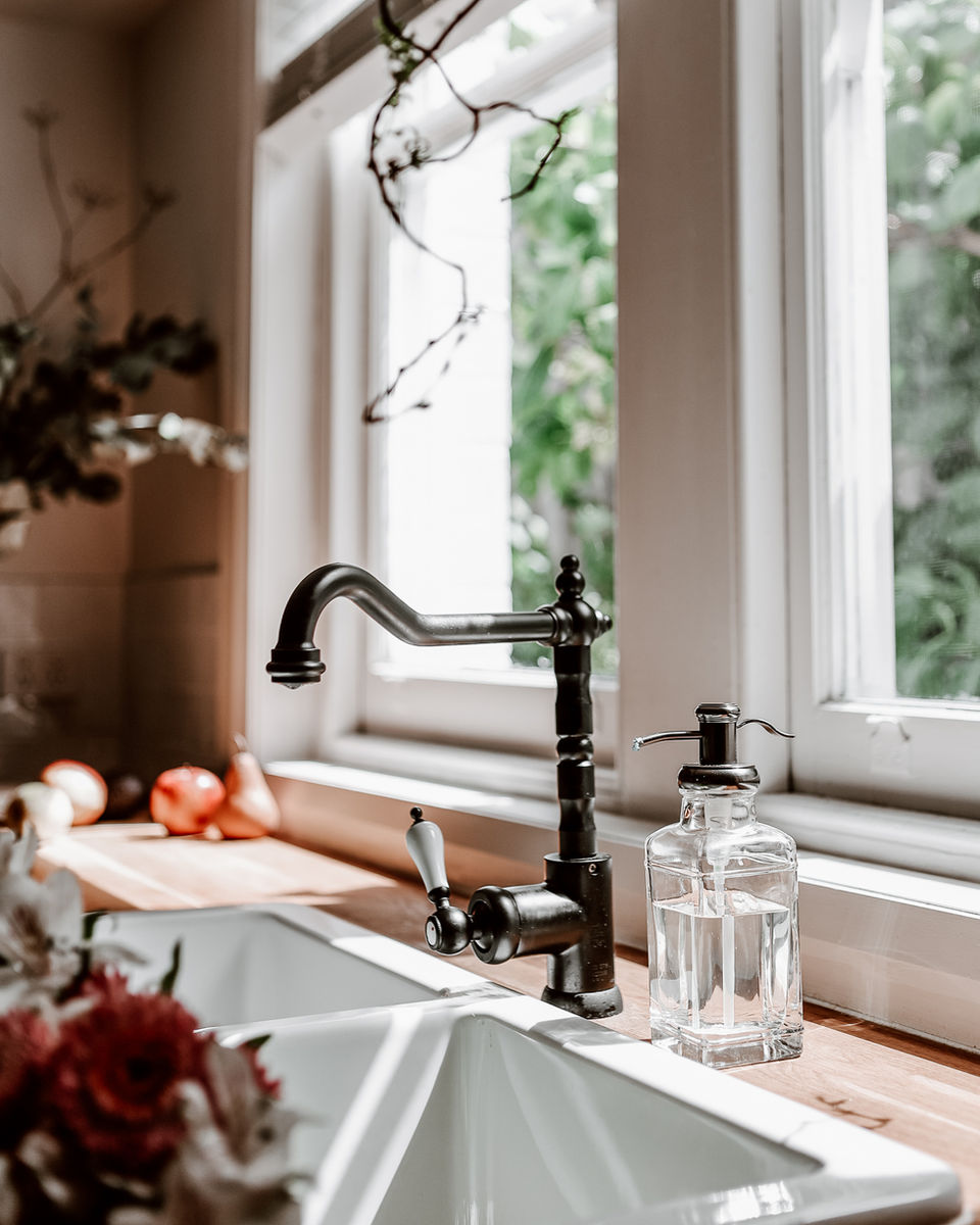 The light streams in through the Hydrangea onto our farmhouse sink with fresh fruit in the background