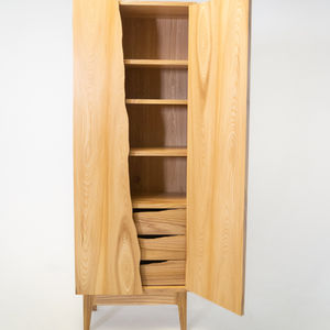 Full view of the front of the cabinet.   The door on the left is closed, the one on the right is open, exposing part of the shelves and drawers within.  The material is elm, a blond wood with a strong grain.  