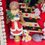 Thumbnail: Christmas diorama-trees-angels-deer head-snowman-pups-vintage ornaments-cardinals-black door-Santa-candy canes