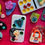 Thumbnail: magic moms-fuchsia shadow box-five ladies-words "magic MOMZ"-dominoes-buttons-mosaic tiles-magnetic alphabet letters