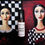 Thumbnail: Creole Poetry Perfume Oil-amber bottle on fabric background of two dark haired girls and checks