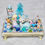 Thumbnail: blue winter wonderland display-reindeer-girl doll-nutcracker-blue tree-vintage angels-snowman bell-wolf-pup-teddy bear-snow