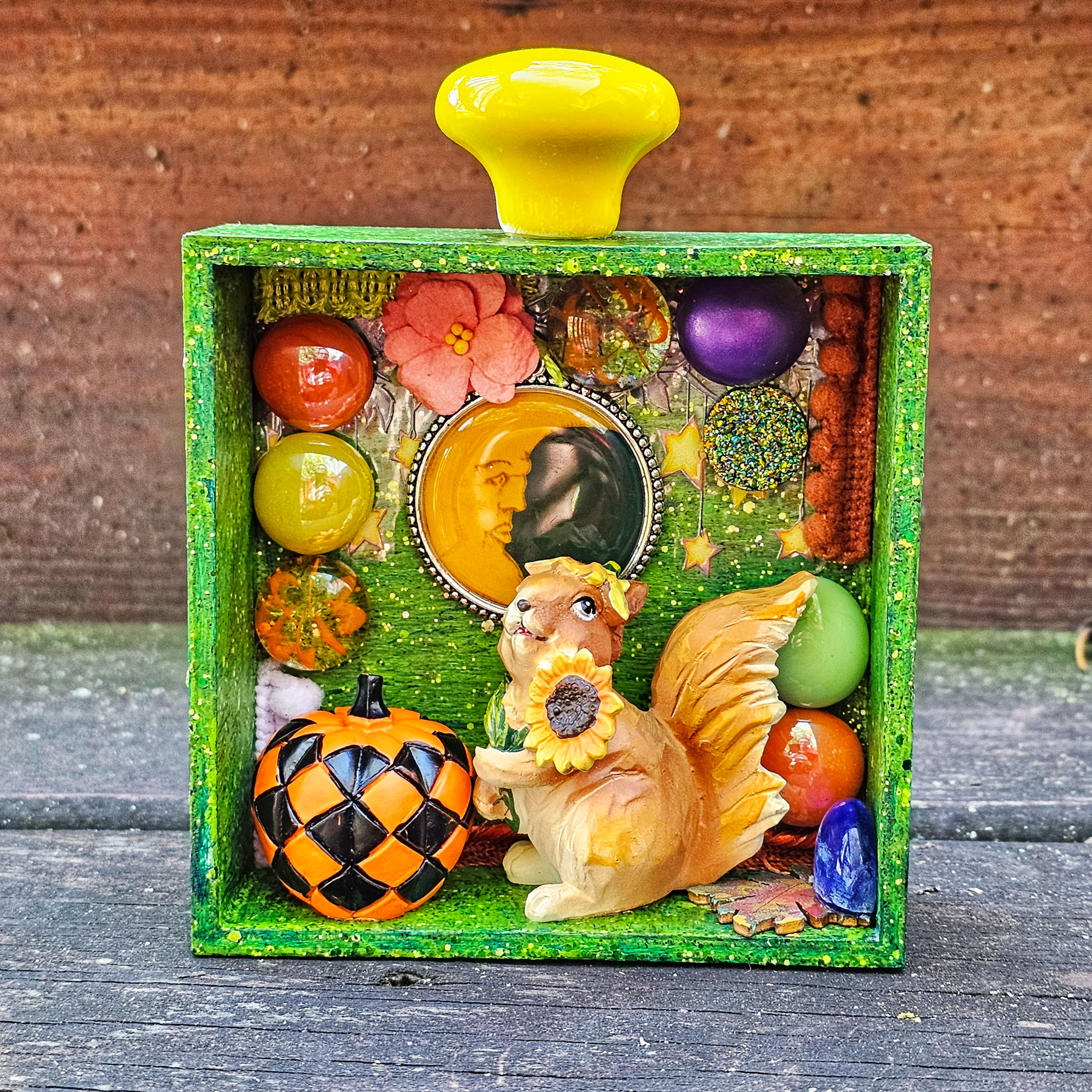 squirrel & pumpkin diorama-green w/yellow drawer pull on top-half moon pendant-glass pieces-fabric-star background