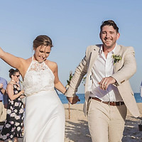 Young couple celebrate after getting married at beach wedding on the Sunshine Coast in Queensland