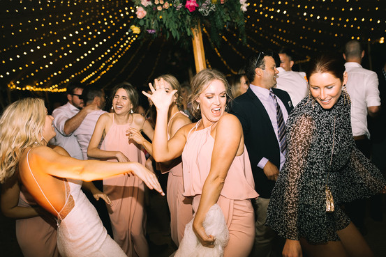 Bride and bridesmaids dance at wedding reception