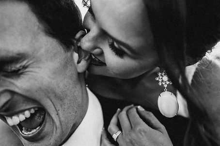 Cute couple posing together kissing and laughing