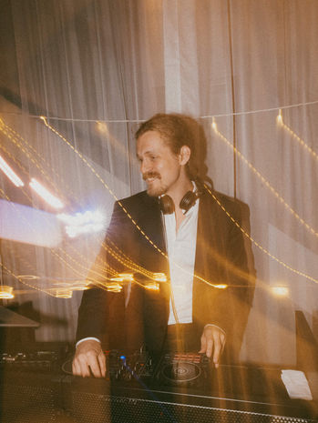 Oscar DJs a dancefloor set at a wedding reception in Flaxton Gardens