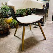 dark wood stained chair with faux white leather upholstery