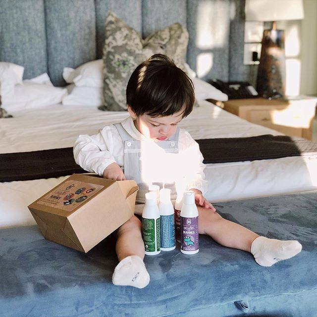 Baby playing with hotel provided toiletries