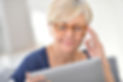 Senior woman with eyeglasses browsing on digital tablet.jpg