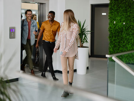 Residents exiting a modern elevator in a newly converted residential building