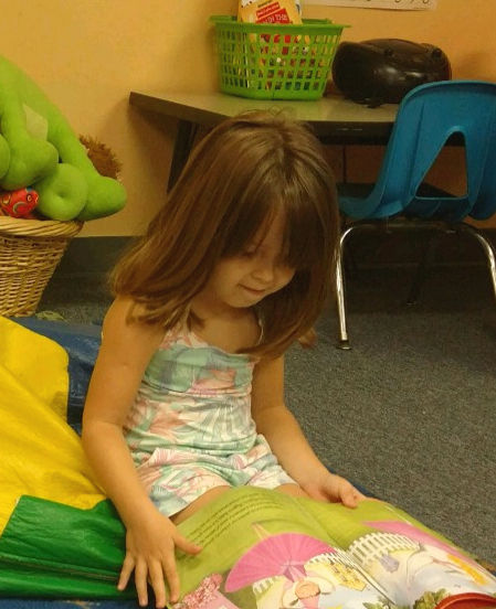 Eye-level view of a child reading in a peaceful learning center
