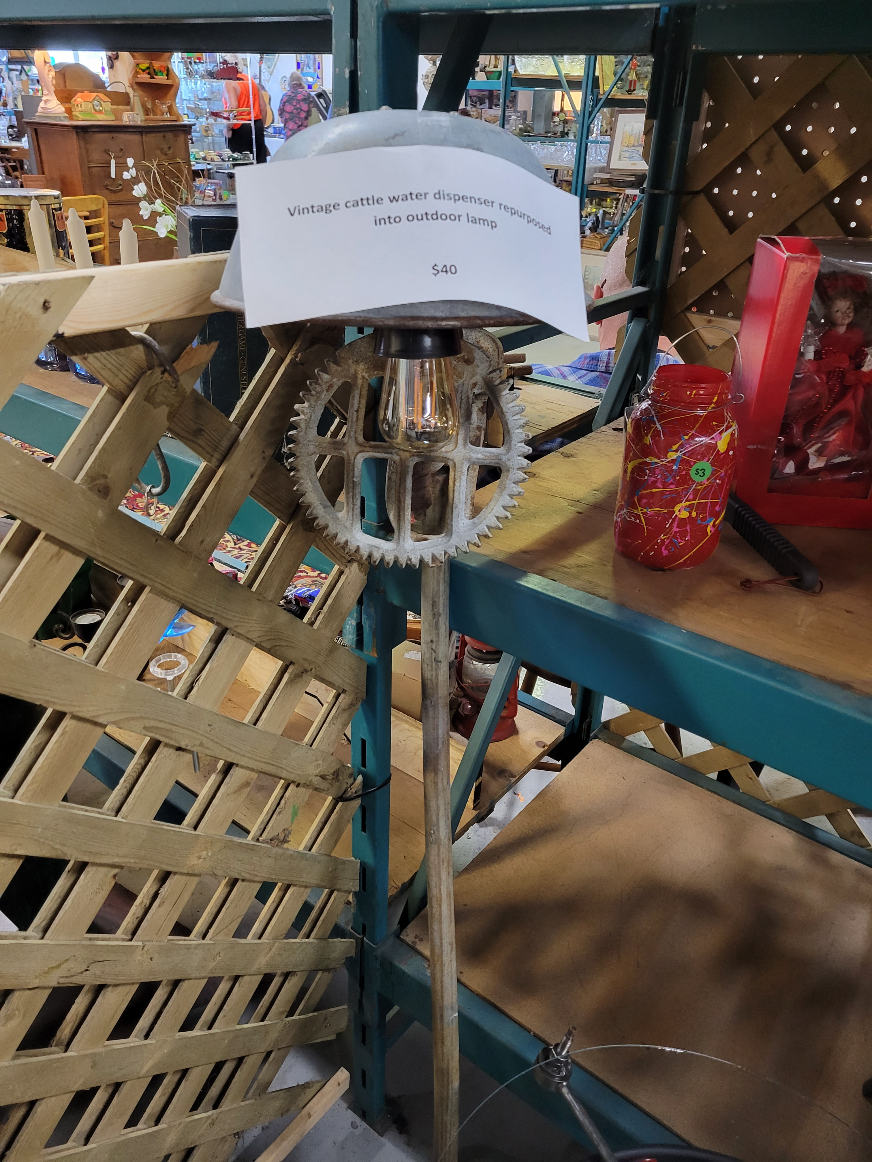 Vintage cattle water dispenser upcycled into outdoor lamp