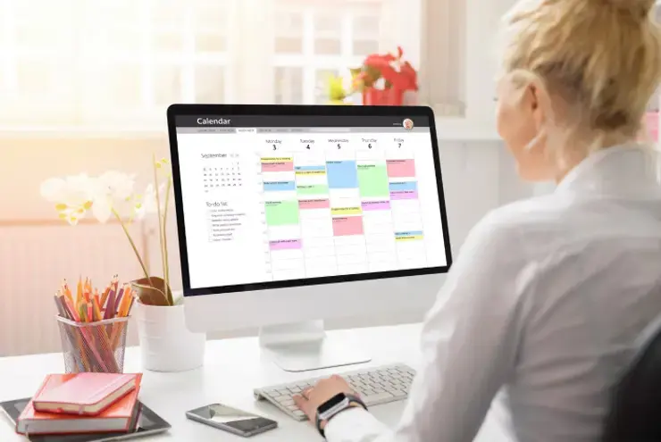 Image of a student using a calendar app to create a coloUr-coded revision timetable on a laptop screen.