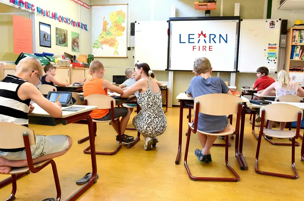 International school students do their school work with their teacher's help.