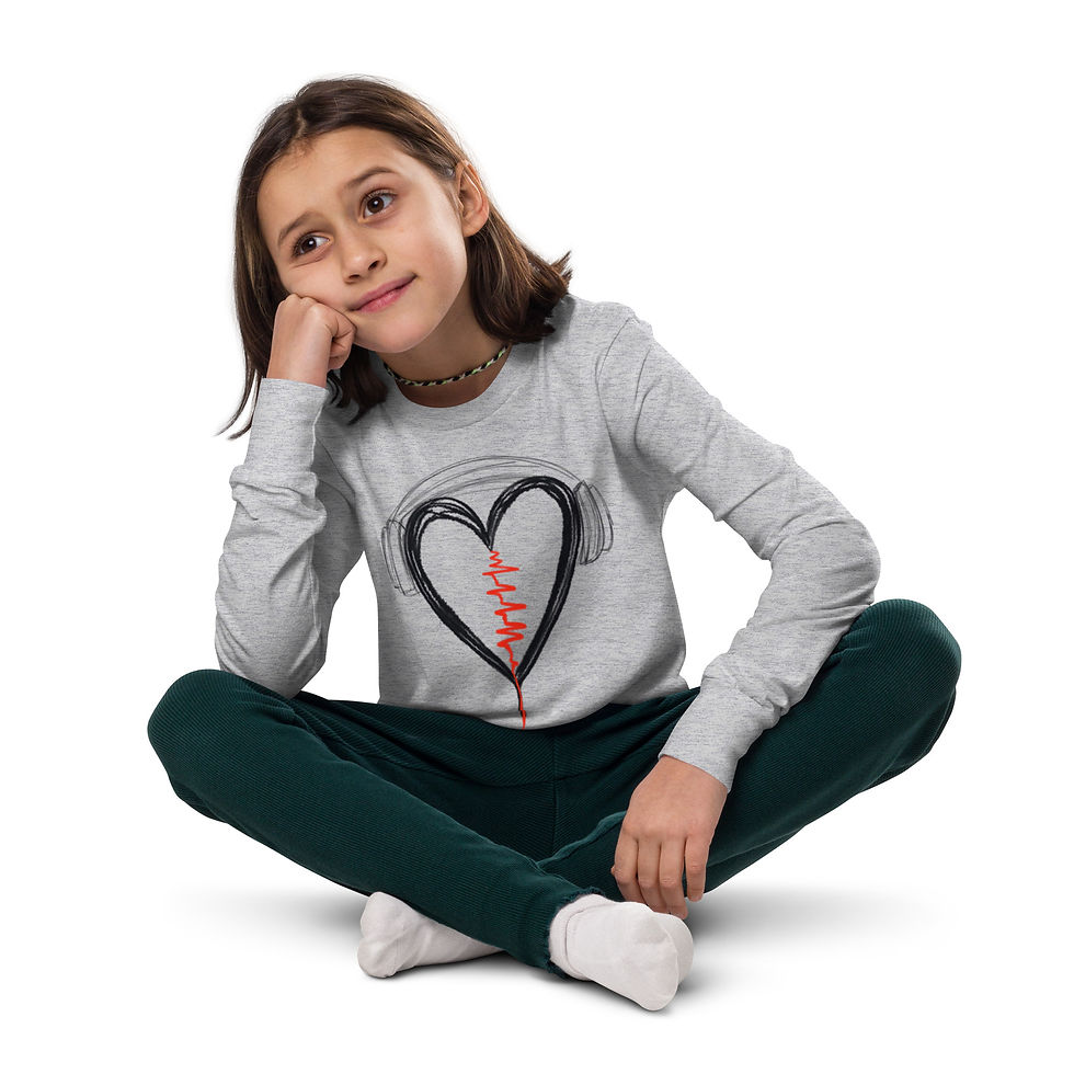 Thumbnail: Young girl sitting, wearing a shirt with a heart design. Thinking pose.