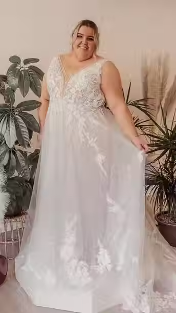 Bride in Floral Lace A-Line Wedding Dress with Deep V-Neckline