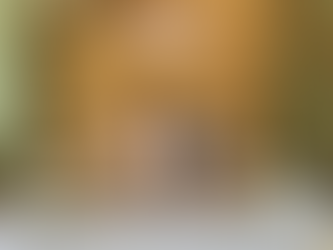 A bride and groom sitting at a decorated wedding table with flowers and candles, catered by Gances’s Complete Catering.