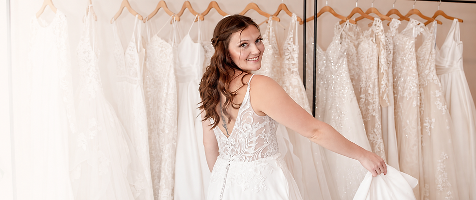 Blush & Ivory Bride Trying On Lace Wedding Dress.png