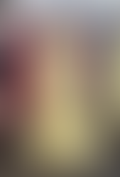 Teen wearing a yellow lace ball gown prom dress with a strapless bodice, standing in a boutique surrounded by colorful prom dresses.